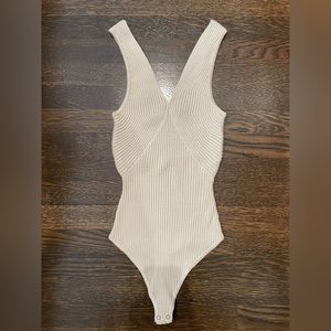 Cream, ribbed body suit. Never worn.